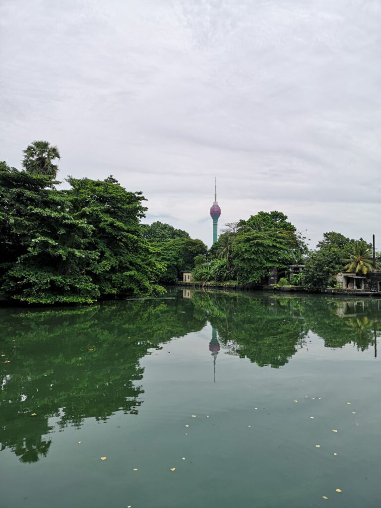 Scenic view of trees and the Lotus Tower, over Beira Lake in Colombo, Sri Lanka