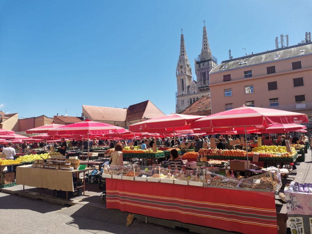 Dolac Farmers Market with the tower of Zagreb Cathedral in the background in Zagreb, Croatia
