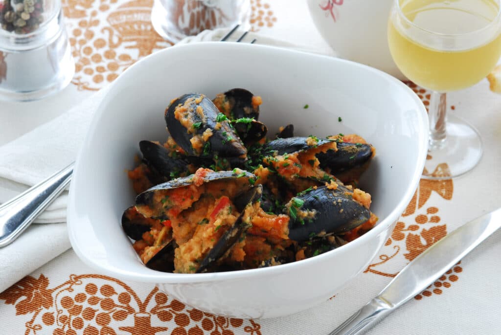 Mussels buzara; mussels served in a bowl with a sauce of wine, olive oil, garlic, parsely, breadcrumbs and tomato