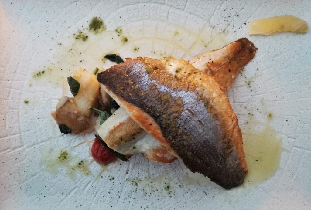 Nicely composed dish of crispy skinned seabass with potatoes and lashings of olive oil