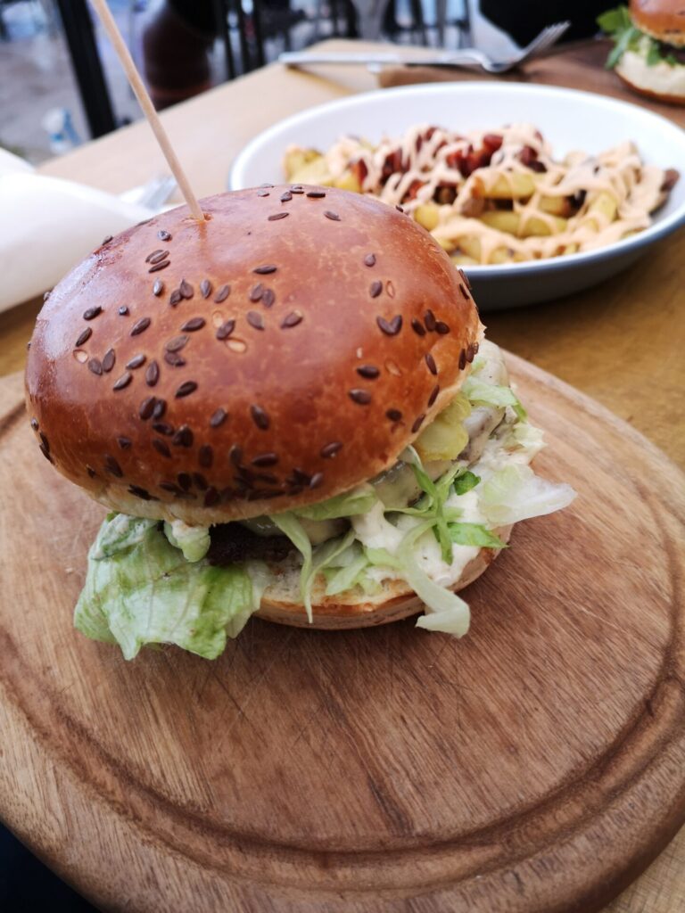 Burger with fries on a wooden board at Submarine, Zagreb. This is where to eat for great burgers
