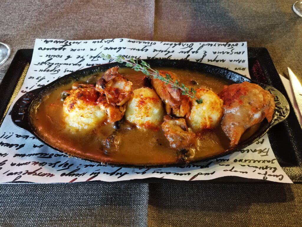 A heart Bulgarian dinner served in an iron dish on decorated paper from a restaurant in Sofia, Bulgaria