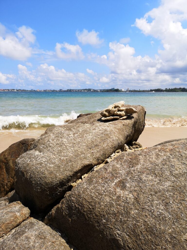 Rocks and the blue waters of the Indian Ocean at Jungle Beach in Galle, Sri Lanka