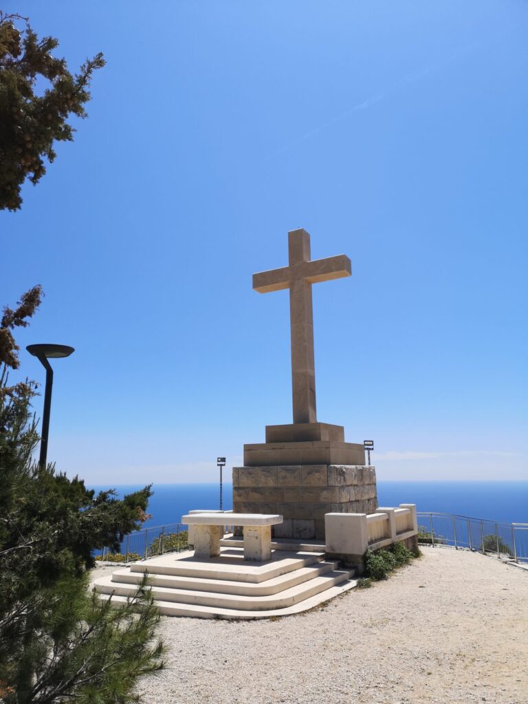 The stone cross looking out at a blue sky and the blue Adriatic in Dubrovnik, Croatia