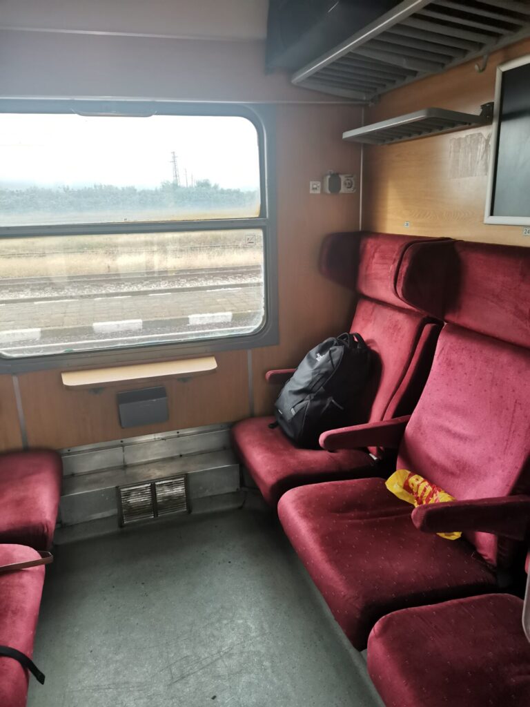 Red velvet seats in a first class train compartment on the Sofia to Burgas train in Bulgaria