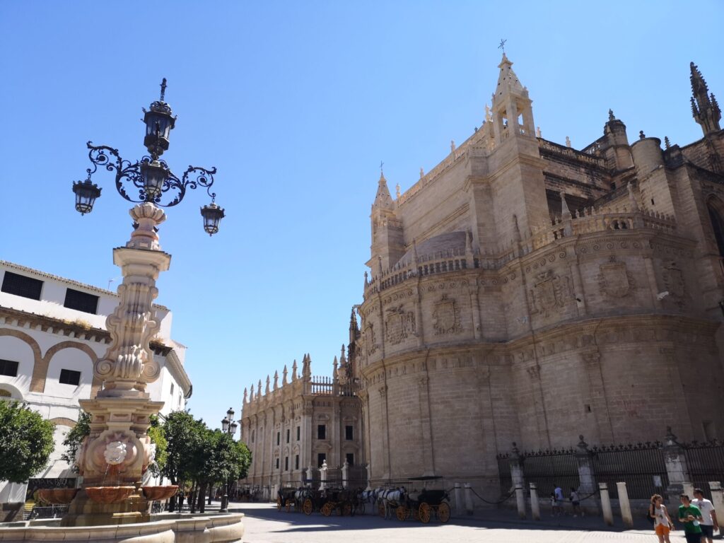 Seville Cathedral and an ornate street light in Seville, Spain