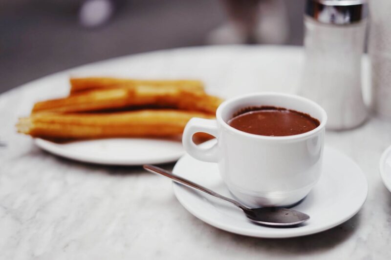 a plate of churros with chocolate in Spain