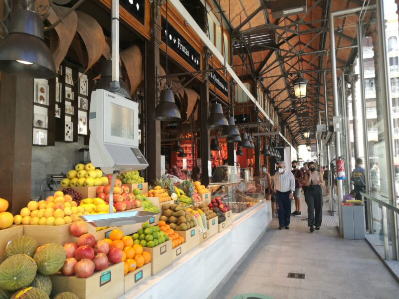 Colourful fruit on a long counter at the industrial San Miguel Market in Madrid, Spain