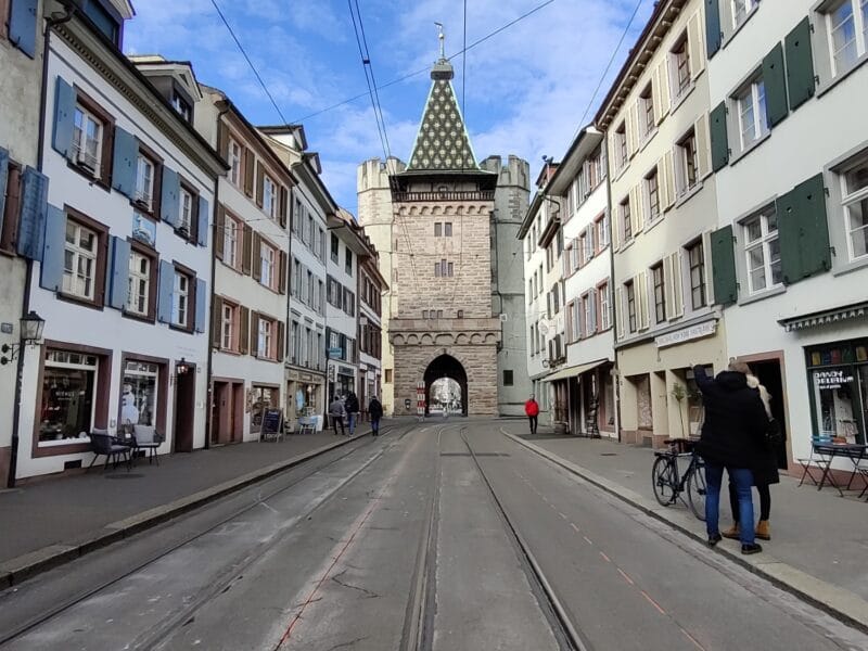 The Spalentor medieval gate facing down an old street in the heart of Basel Old Town